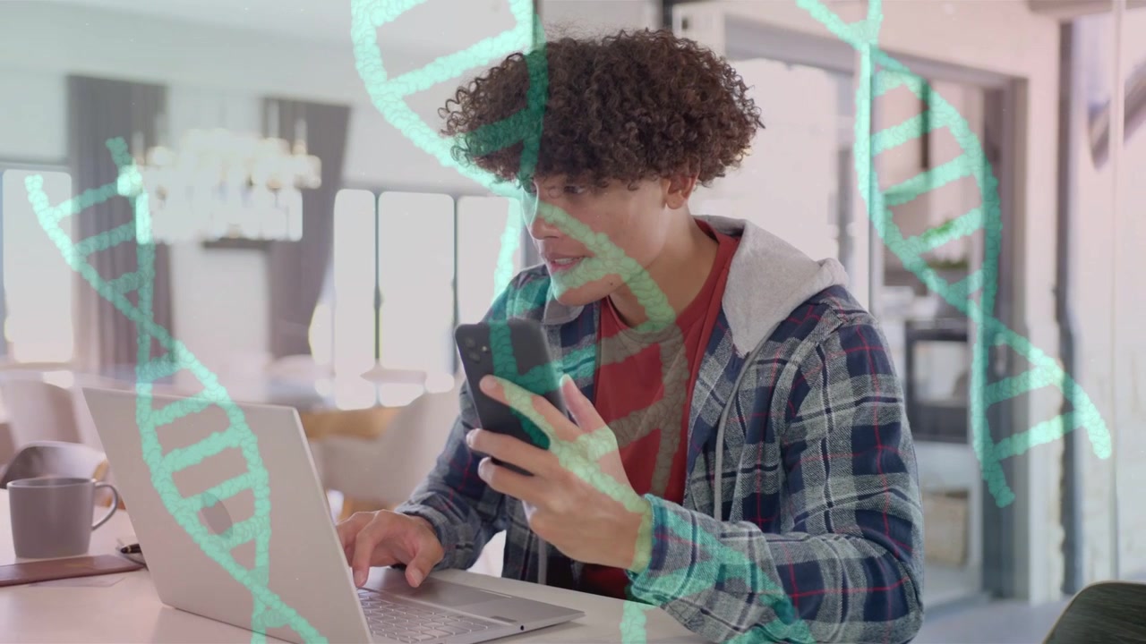 Vertical video: Man sitting table typing on laptop tapping phone, DNA strands visualizing genetics