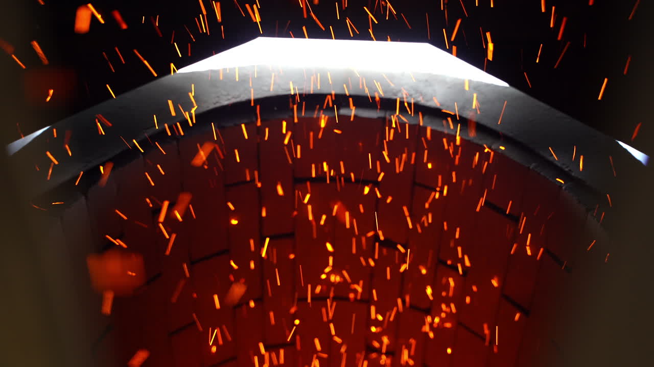 Fast shining sparkles flying quickly from their source. Bright ablaze particles at the brick backdrop. Close up.