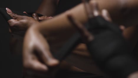 studio shot of women putting on boxing wraps on hands before exercising together 1