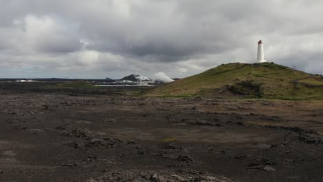 volcanic landscape in iceland with iconic reykjanesviti lighthouse on hill