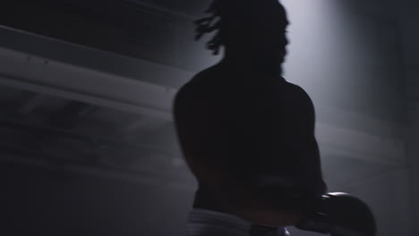 close up shot of two male boxers wearing gloves in boxing ring fighting in boxing match with low key lighting 2