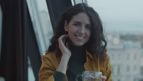 Portrait-of-Cheerful-Woman-with-Tea-Cup-in-Office