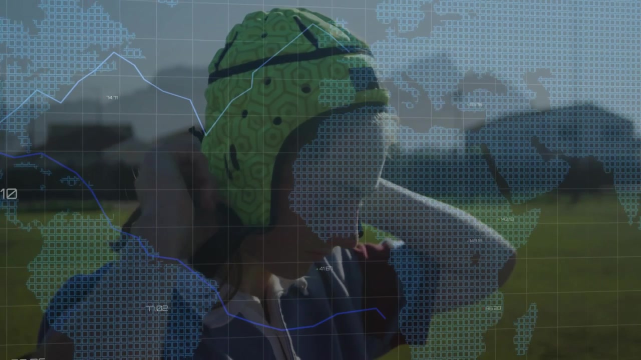 female rugby teammates leaning foreheads with technology overlay showing map grid and line graphs