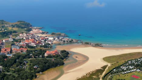 aerial drone view of summertime holiday coastline in cantabria island, pan, day