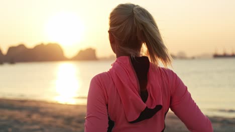 handheld view of young woman warming up before jogging