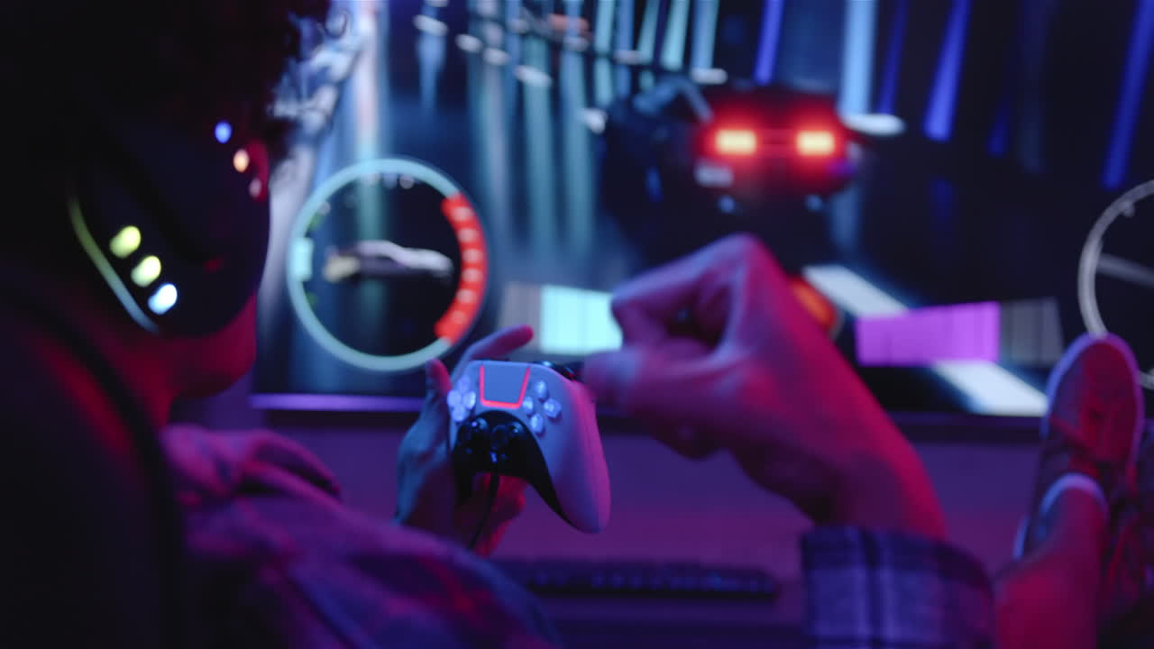 Using game controller, man playing video game and wearing headphones, enjoying leisure time