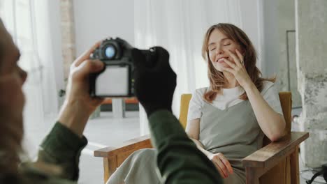 Young Feminine Woman Posing in Armchair in front of Photographer