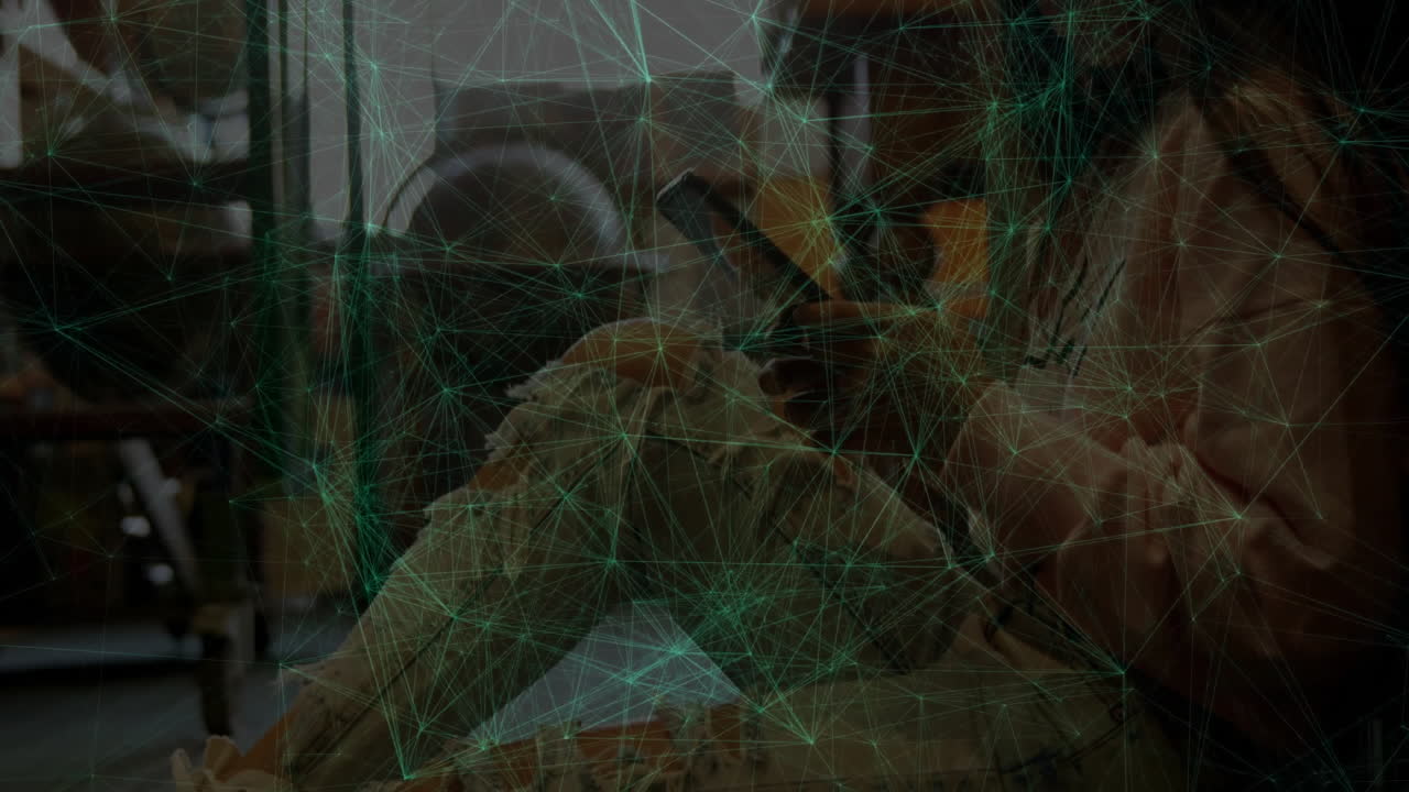 Female welder kneeling on manufacturing floor, operating welding torch displaying network overlay