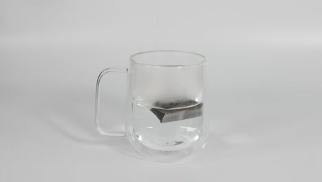 sequence of tea infusion in a transparent mug