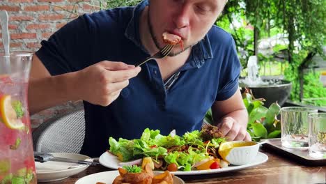 man enjoying a meal outdoors