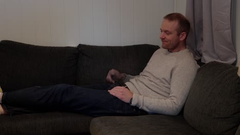 sick day, man coping with cold and flu symptoms in sofa corner