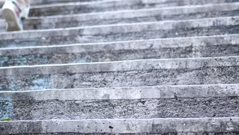 person walking up concrete stairs