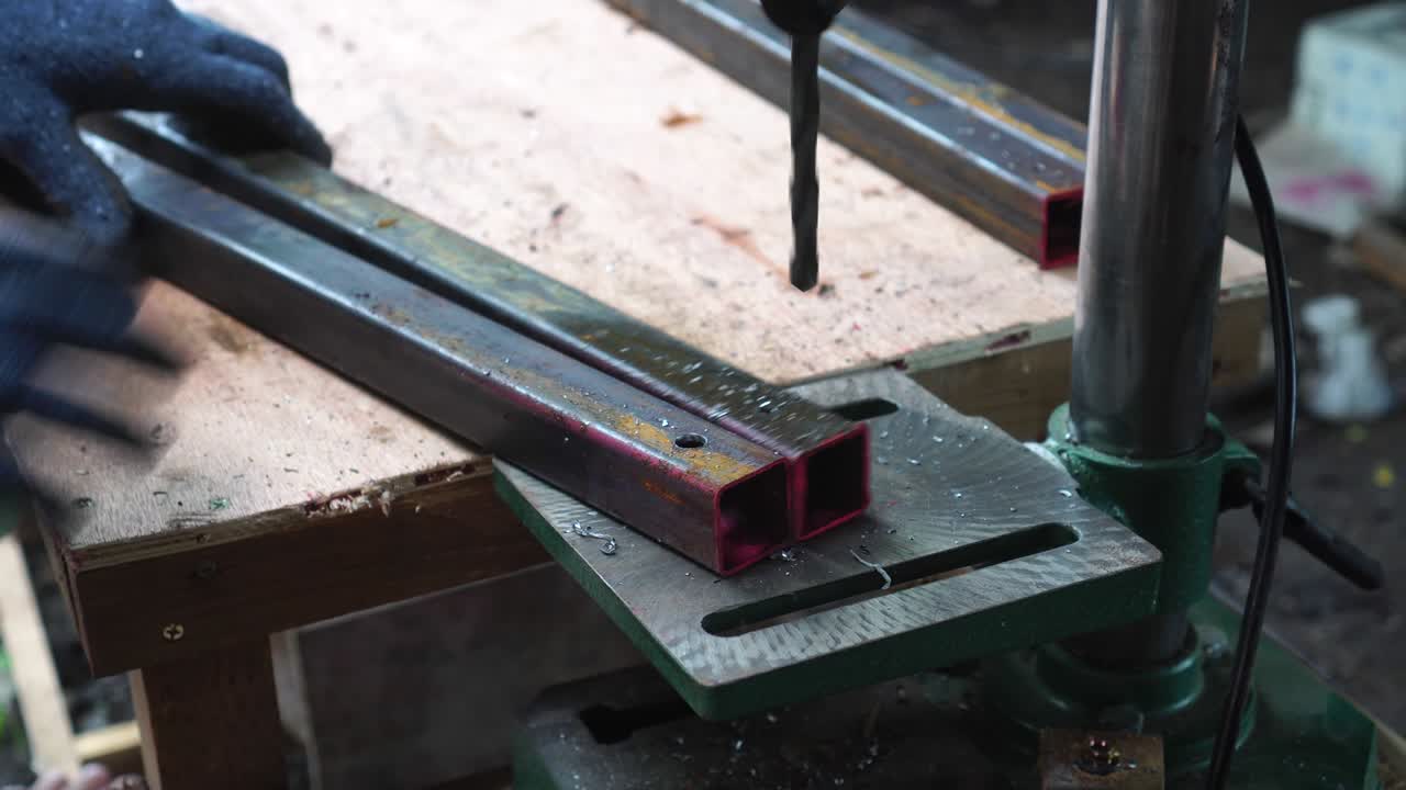 In the woodworkers shop the cnc drill is drilling a letters in to the wooden plank to make a sine, close up footage.