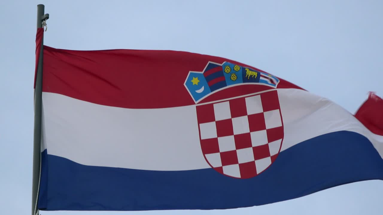4K. Croatia flag waving in the wind on a mast. Coat of arms of Croatia