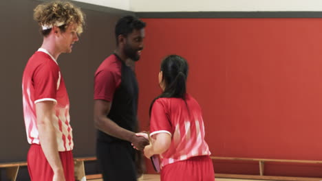 playing table tennis, teammates discussing strategy during practice session indoors