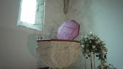 ornate baptismal font with floral decor inside a historic church, portugal