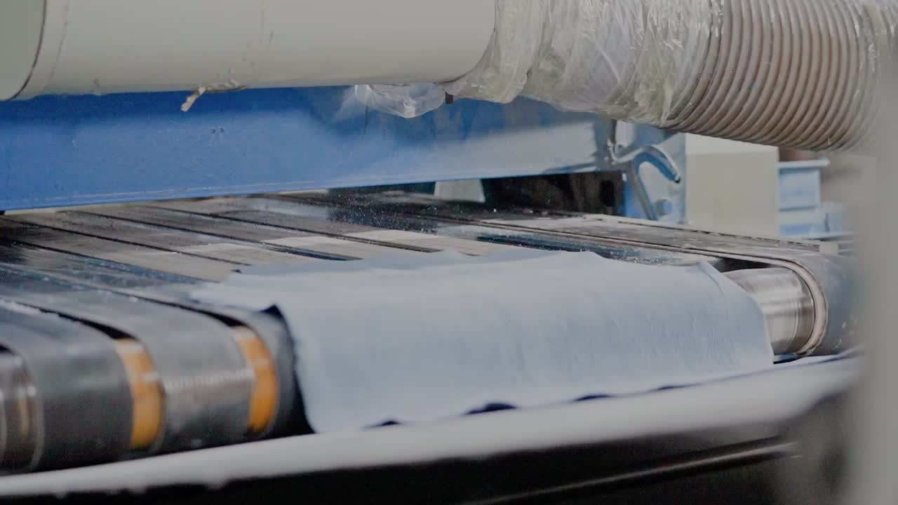 Leather Products Being Fed Through A Industrial Automated Machine During Manufacturing Process