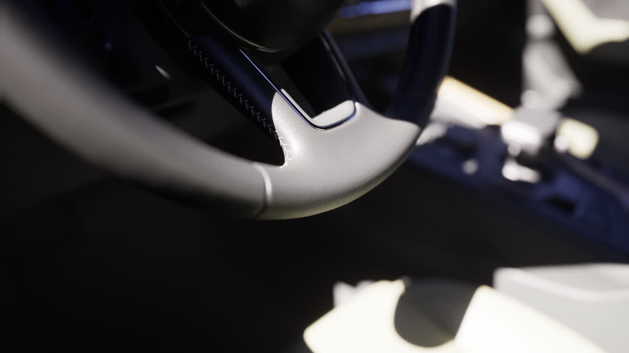 Close view of a modern car steering wheel in a well lit interior space