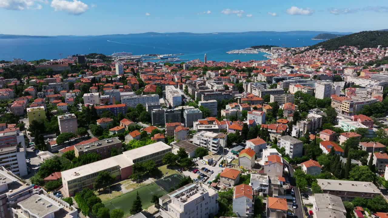 Modern Apartment Buildings In Coastal City Of Split In Croatia. Adriatic Sea Revealed In Background. aerial tilt-up shot