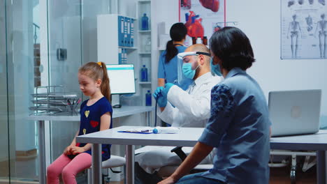 pediatric physician with stethoscope listening breath of girl