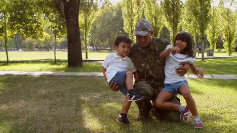 happy military father wearing uniform, playing and posing with his kids