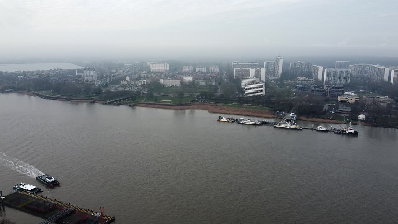 Aerial dolly shot of schelde river in Antwerp,Belgium with boats and skyline