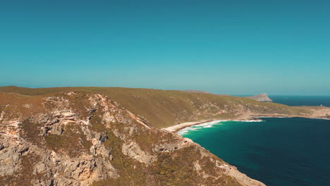 Aerial,-tracking,-drone-shot-of-the-sharp-point-lookout,-a-beach-and-the-Cave-Point-Light-House-in-the-background,-sunny-day,-in-Albany,-western-Australia