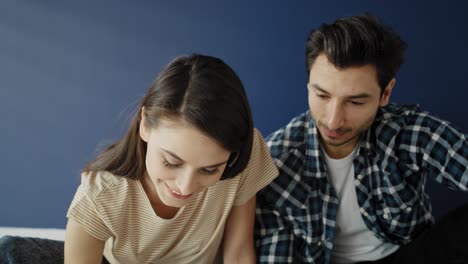 Tilt-up-video-of-couple-looking-at-blueprint-in-new-house.