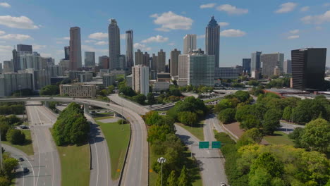 Cityscape-with-downtown-high-rise-office-buildings-against-blue-sky-with-white-clouds