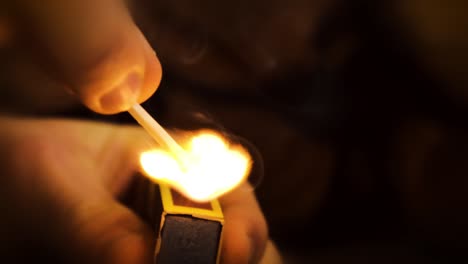 hand striking match slow motion combustion bright hot flame