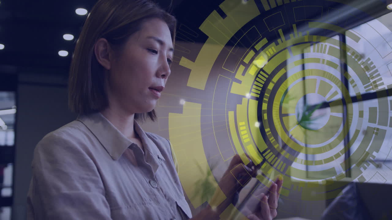 Using smartphone, businesswoman interacting with digital interface in office setting