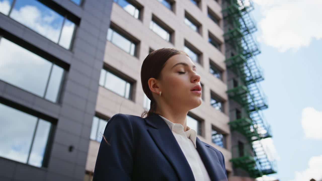 Angry executive shouting smartphone loudspeaker at business district closeup