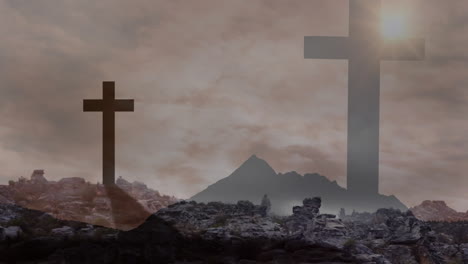 cloudy sky over silhouetted crosses and rocky landscape creating dramatic scene