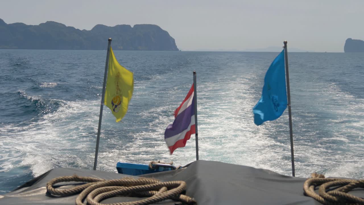 Ferry Boat With Waving Flags Cutting Through The Andaman Sea Waters. POV Shot