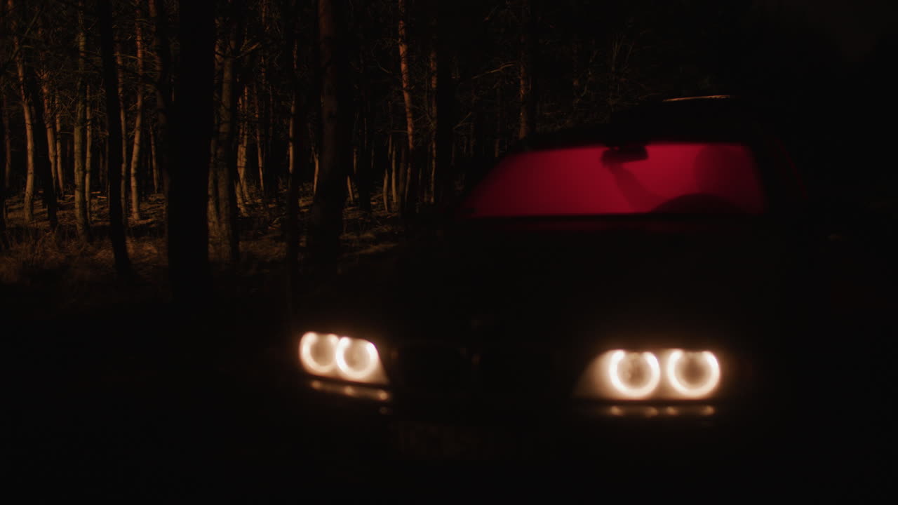 Car in the Dark Forest at Night