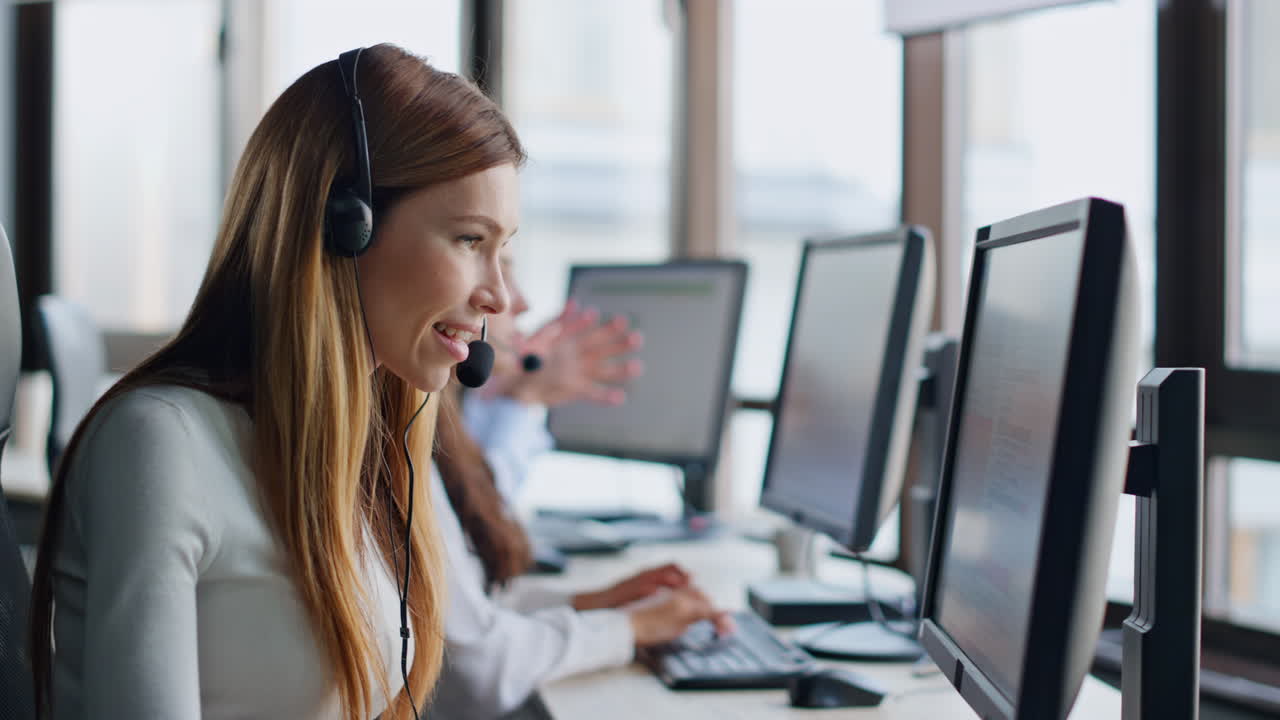 Smiling operator typing computer in data center. Joyful woman assistant at work.