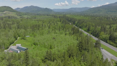 aerial of bellingham, washington pushing alongside highway and towards mountains and foothills