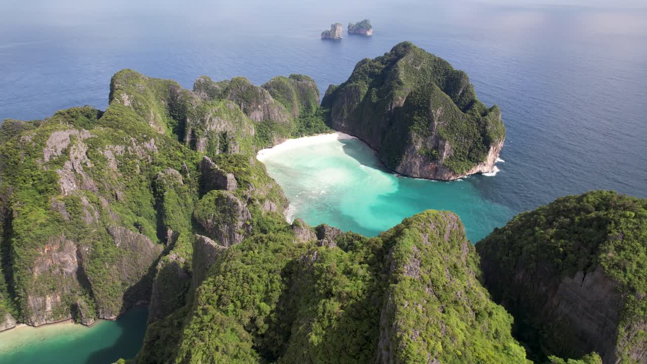 Aerial drone video of Phi Phi Leh with Maya Bay and Pileh Lagoon, Krabi province, Thailand. Aerial top view of amazing tropical island with turquoise water and white beach, famous travel destination.