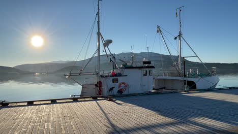 view of a fishing boat at fauske pier, northern scandinavia, norway, bright sunny day