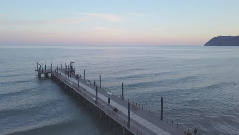 alassio pier aerial view with people at sunset