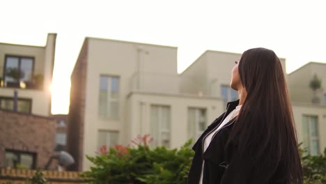 gorgeous-cheeky-model-dancer-enjoying-sunset-golden-hour-in-spanish-looking-neighborhood-with-lovely-houses-and-flowers-sticking-her-tongue-out-smiling-being-positive-enjoying-cute-slow-motion