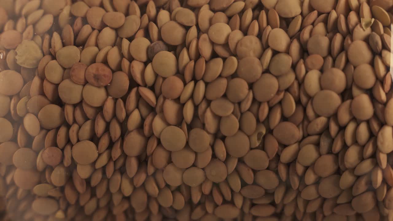 lentils spinning in a transparent barrel. close-up shot