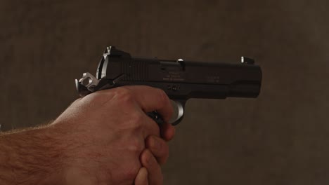 1911 model pistol being fired multiple times until it is empty in slow motion