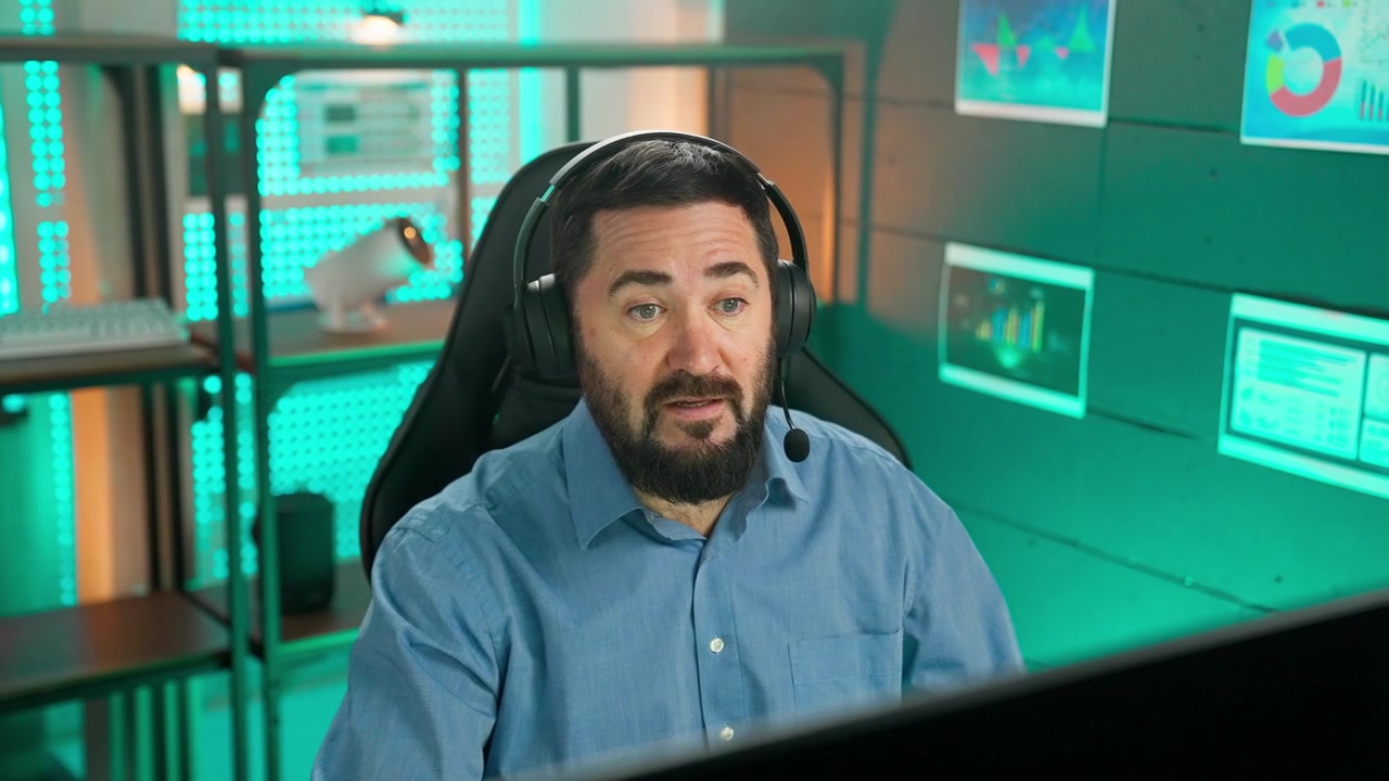 Bearded Man in Headset Talking on Video Call in Modern Office