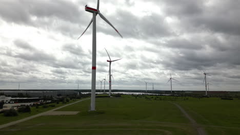 wind turbines generate electricity on moody day, aerial view