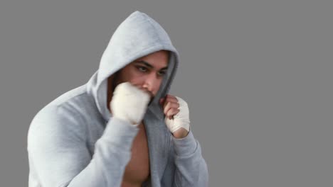 muscular man wearing grey hood