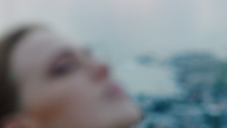 close-up-portrait-of-beautiful-young-woman-looking-up-praying-exploring-spirituality-contemplating-future-on-cloudy-seaside
