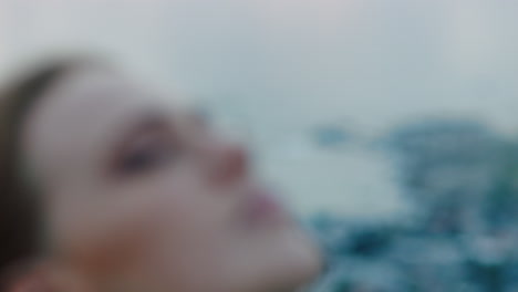 close up portrait of beautiful young woman looking up praying exploring spirituality contemplating future on cloudy seaside