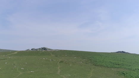 wide shot of two tors in the distance on dartmoor, england