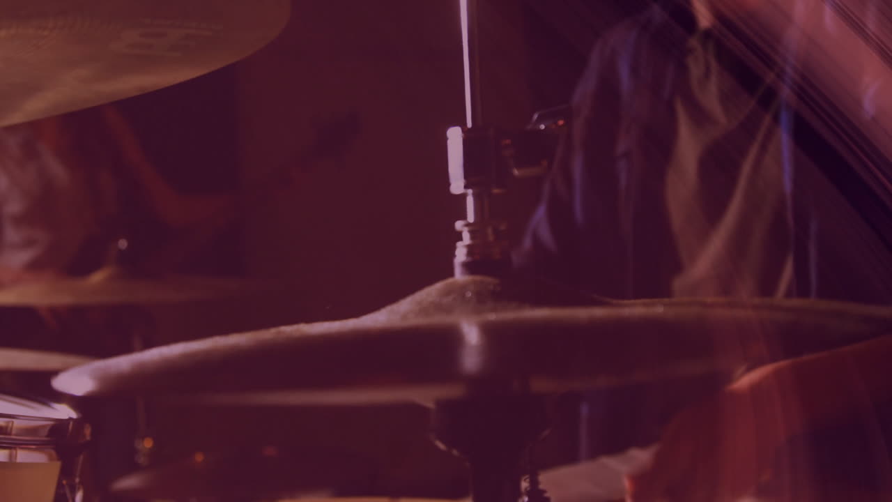 Drum cymbal getting highlighted in animated close-up, showing mounting clamp under warm red lights